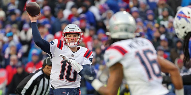 Mac Jones (10) of the New England Patriots attempts a pass during the third quarter against the Buffalo Bills at Highmark Stadium on January 8, 2023 in Orchard Park, NY 