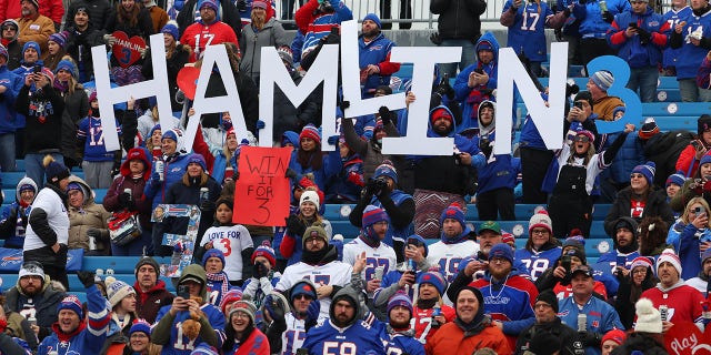 Buffalo Bills fans hold signs in support of Buffalo Bills safety Damar Hamlin before the game between the Buffalo Bills and the New England Patriots at Highmark Stadium on January 8, 2023 in Orchard Park, New York .