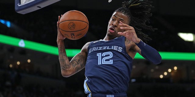 Ja Morant, #12 of the Memphis Grizzlies, grabs a rebound during the first half against the San Antonio Spurs at FedExForum on January 11, 2023, in Memphis, Tennessee. 