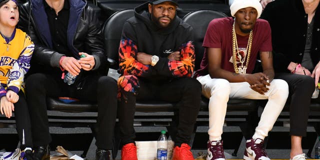 Floyd Mayweather Jr. (C) attends a basketball game between the Los Angeles Lakers and the Dallas Mavericks at Crypto.com Arena on January 12, 2023, in Los Angeles, California.