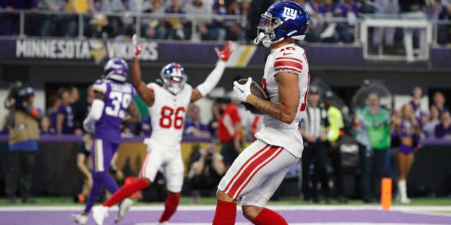 Isaiah Hodgins #18 of the New York Giants catches a touchdown pass during the first quarter against the Minnesota Vikings in the NFC Wild Card playoff game at U.S. Bank Stadium on January 15, 2023 in Minneapolis, Minnesota.