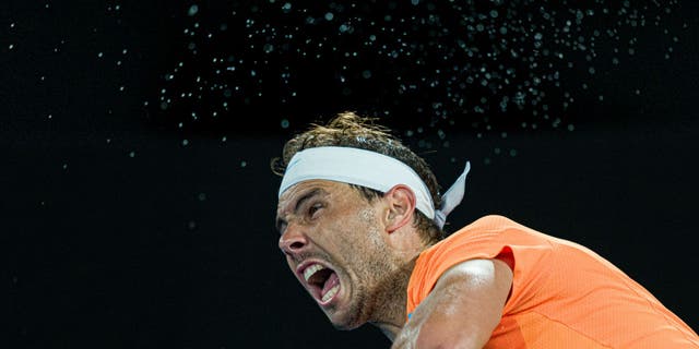 Rafael Nadal of Spain serves in the round two singles match against Mackenzie McDonald of the United States during day three of the 2023 Australian Open at Melbourne Park on January 18, 2023, in Melbourne, Australia.
