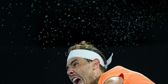 Rafael Nadal of Spain serves in the second round singles match against Mackenzie McDonald of the United States during day three of the 2023 Australian Open at Melbourne Park on January 18, 2023 in Melbourne, Australia.