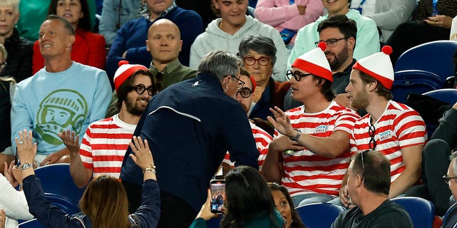 Fans in the crowd dressed up in 'Where's Waldo?' costumes are seen during the Djokovic-Couacauo match at the Rod Laver Arena during the Australian Open on Jan. 19, 2023, in Melbourne.