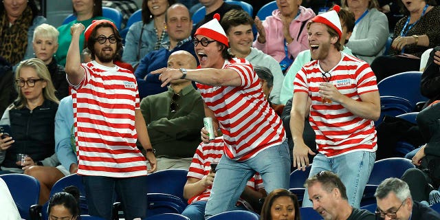 Fans in the crowd dressed up in 'Where's Waldo?' costumes are seen during the match between Novak Djokovic and Enzo Couacauo at the Australian Open on Jan. 19, 2023, in Melbourne.