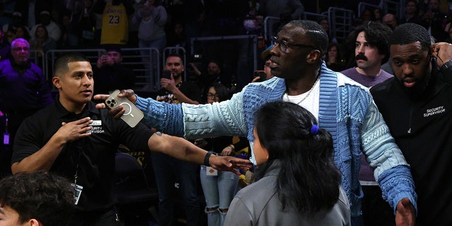 LOS ANGELES, CALIFORNIA - JANUARY 20: Shannon Sharpe is retrained by security from Ja Morant #12 of the Memphis Grizzlies after a verbal altercation following the end of the first half against the Los Angeles Lakers at Crypto.com Arena on January 20, 2023 in Los Angeles, California. 