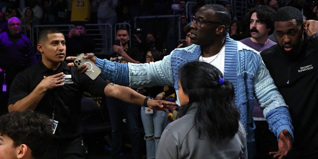 LOS ANGELES, CALIFORNIA - JANUARY 20: Shannon Sharpe is retrained by security from Ja Morant #12 of the Memphis Grizzlies after a verbal altercation following the end of the first half against the Los Angeles Lakers at Crypto.com Arena on January 20, 2023 in Los Angeles, California.