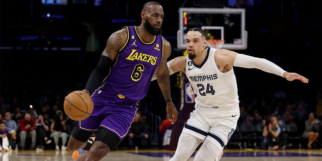 LeBron James, number 6 of the Los Angeles Lakers, drives to the basket over Dillon Brooks, number 24 of the Memphis Grizzlies, during the first half at Crypto.com Arena on January 20, 2023 in Los Angeles, California. 