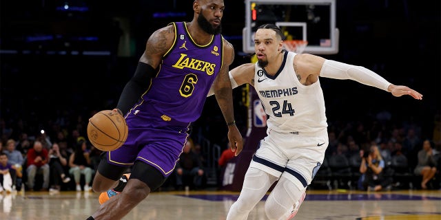 LeBron James, number 6 of the Los Angeles Lakers, drives to the basket over Dillon Brooks, number 24 of the Memphis Grizzlies, during the first half at Crypto.com Arena on January 20, 2023 in Los Angeles, California. 