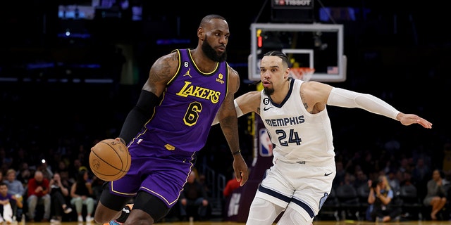 LOS ANGELES, CALIFORNIA - JANUARY 20: LeBron James #6 of the Los Angeles Lakers drives to the basket on Dillon Brooks #24 of the Memphis Grizzlies during the first half at Crypto.com Arena on January 20, 2023 in Los Angeles, California. 