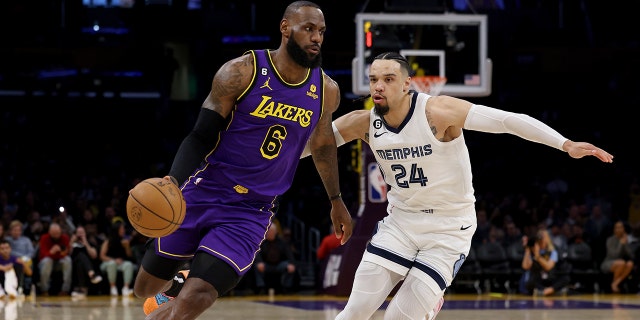 LOS ANGELES, CALIFORNIA - JANUARY 20: LeBron James #6 of the Los Angeles Lakers drives to the basket on Dillon Brooks #24 of the Memphis Grizzlies during the first half at Crypto.com Arena on January 20, 2023 in Los Angeles, California . 