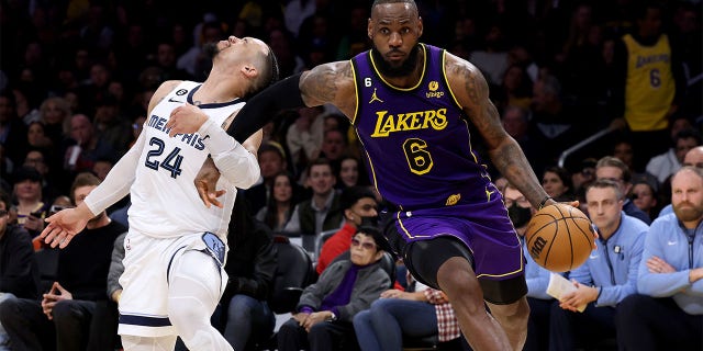 LeBron James, #6 of the Los Angeles Lakers, drives past Dillon Brooks, #24 of the Memphis Grizzlies, during a 122-121 Lakers win at Crypto.com Arena on January 20, 2023, in Los Angeles, California.