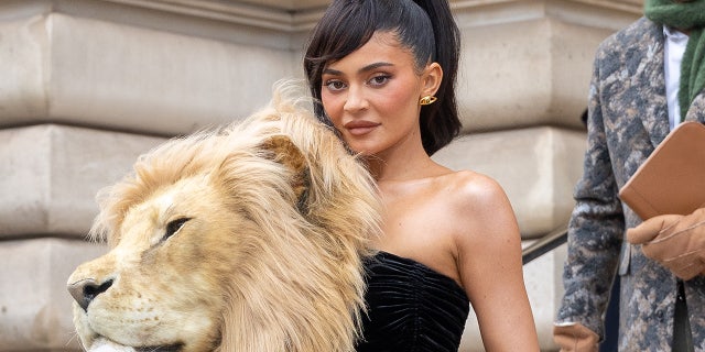 Kylie Jenner attended the Schiaparelli Haute Couture Spring Summer 2023 show during Paris Fashion week. Her dress featured a large embroidered head of a lion.