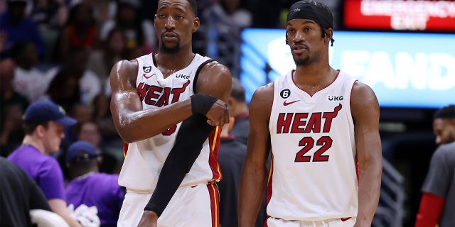 Bam Adebayo (13) and Jimmy Butler (22) of the Miami Heat react against the New Orleans Pelicans during a game at the Smoothie King Center on January 18, 2023 in New Orleans. 