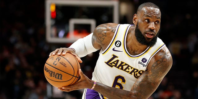 LeBron James of the Los Angeles Lakers looks to pass against the Trail Blazers at the Moda Center on January 22, 2023 in Portland, Oregon.