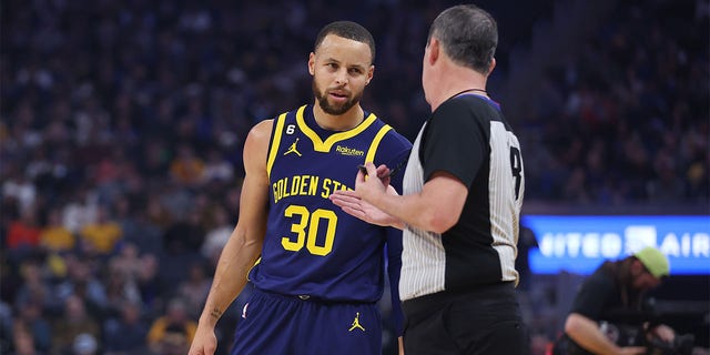 Stephen Curry, number 30 of the Golden State Warriors, speaks with referee Matt Boland, number 18, during the game against the Memphis Grizzlies at the Chase Center on January 25, 2023 in San Francisco, California. 