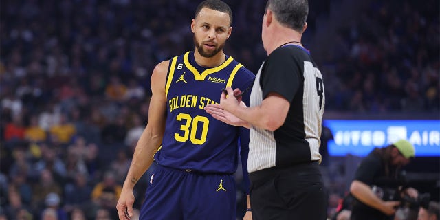 Stephen Curry, number 30 of the Golden State Warriors, speaks with referee Matt Boland, number 18, during the game against the Memphis Grizzlies at the Chase Center on January 25, 2023 in San Francisco, California. 