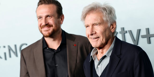 Jason Segel and Harrison Ford smile together at the premiere of their show "Shrinking"