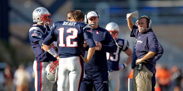 New England Patriots quarterback Tom Brady (12), head coach Bill Belichick and offensive coordinator Bill O'Brien on the field before a game against the Baltimore Ravens at Gillette Stadium in Foxboro, Massachusetts, on October 4, 2009.