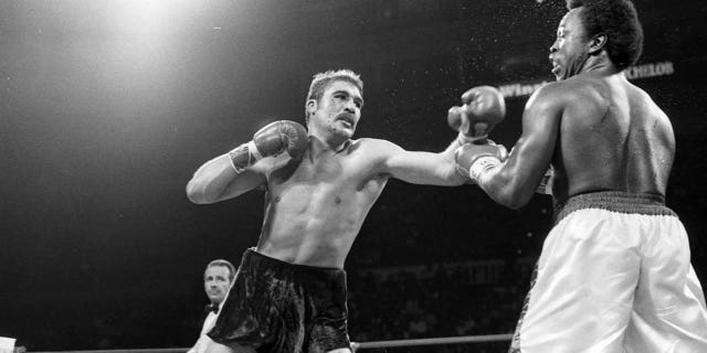 Gerrie Coetzee, left, lands a punch against Michael Dokes during the fight at Richfield Coliseum in Richfield, Ohio. Coetzee won by a KO in the 10th round. 