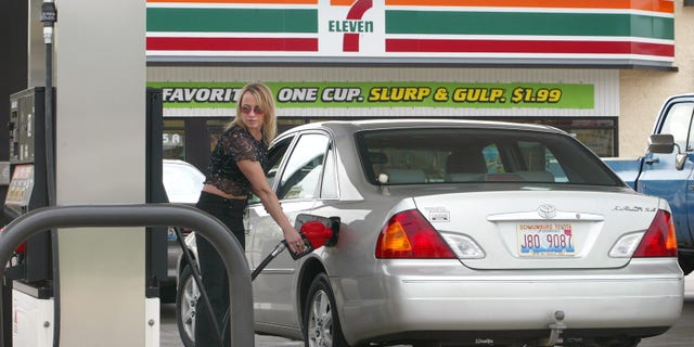 A customer fills up gas at a 7-Eleven store on May 9, 2003 in Des Plaines, Illinois. 