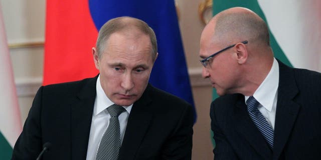 Russian President Vladimir Putin listens to Rosatom state nuclear energy corporation Chief Sergei Kirienko (R) during a meeting with Hungarian Prime Minister Viktor Orban (unseen) in the Novo-Ogaryovo State Residence in Moscow on January 14, 2014 in Moscow, Russia. 