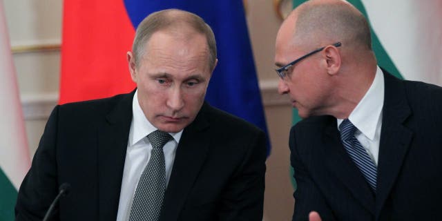 Russian President Vladimir Putin listens to Rosatom state nuclear energy corporation Chief Sergei Kirienko (R) during a meeting with Hungarian Prime Minister Viktor Orban (unseen) in the Novo-Ogaryovo State Residence in Moscow on January 14, 2014 in Moscow, Russia.