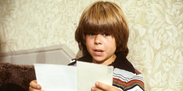 Adam Rich reading two pieces of paper in "Eight Is Enough" episode