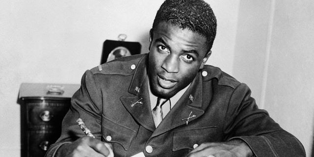 Jackie Robinson signs with a baseball team