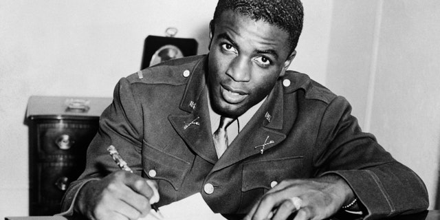 Jackie Robinson signs with a baseball team