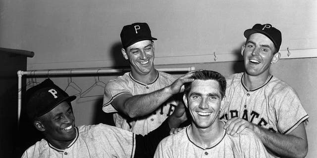 Jubilant members of the Pittsburgh Pirates celebrate in the locker room here 6/6 after beating the Cubs, 8-2, to retain their narrow lead as the league leaders.