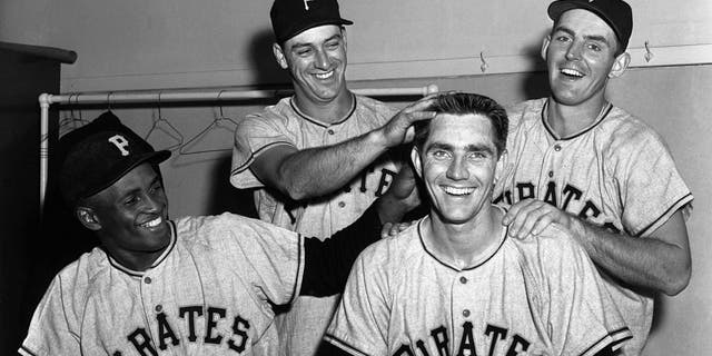 Jubilant members of the Pittsburgh Pirates celebrate in the locker room here 6/6 after defeating the Cubs 8-2 to maintain their slim lead as the league leaders.