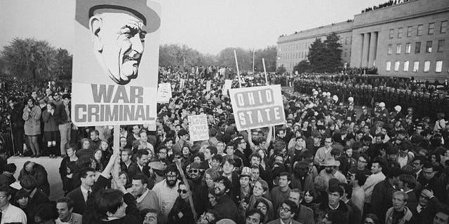 Peace demonstrators display a sign referring to the president as a war criminal during a huge anti-Vietnam war protest at the Pentagon in Washington, D.C. Undated photo. 