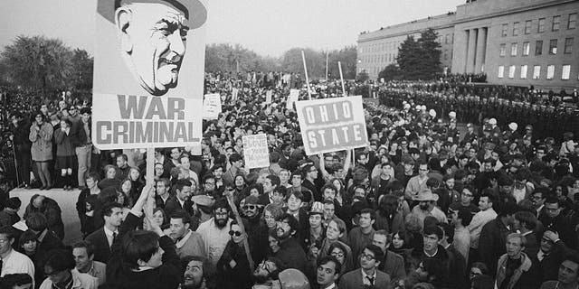 Peace demonstrators display a sign referring to the president as a war criminal during a huge anti-Vietnam war protest at the Pentagon in Washington, D.C. Undated photo. 