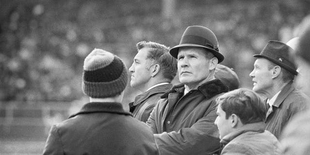 Dallas Cowboys head coach Tom Landry is shown at center during a game. 