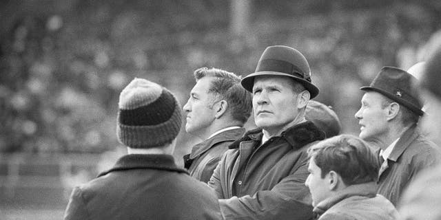 Dallas Cowboys head coach Tom Landry is shown at center during a game.