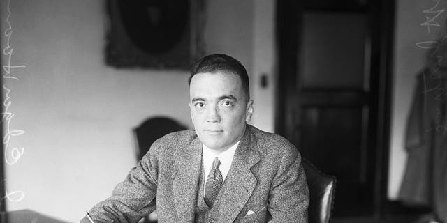 (Original Caption) 1928: Washington, D.C.: J. Edgar Hoover, director of the Federal Bureau of Investigation, sits at his desk in the Justice Department. Hoover played a key role in the Palmer Raids; he was named FBI director in 1924. 
