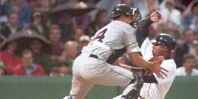 Boston Red Sox' Lee Tinsley is safe at home on Mo Vaughn's sacrifice fly against California Angels catcher Jorge Fabregas in the first inning June 8 at Fenway Park.