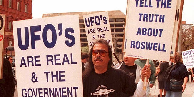 A group of protesters marches in front of the General Accounting Office March 29 to raise awareness about an examination being conducted by the GAO for documents about a weather balloon crash at Roswell, N.M., in 1947. The protesters believe the balloon was a crashed UFO. 