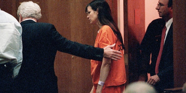 Defense attorney George Parnham, left, escorts his client, Andrea Yates, at the Harris County 230th District Court for a pretrial hearing on Aug. 8, 2001, in Houston.
