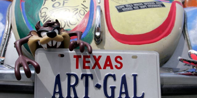 The license plate says it all on "Fusion of Contradiction" during the Everyone's Art Car Parade May 14, 2005 in Houston, Texas.
