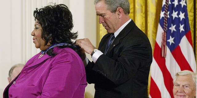 President George W. Bush presents the Presidential Medal of Freedom, the nation's highest civil award, to singer Aretha Franklin as actor Andy Griffith (far right) watches in the East Room of the White House on Nov. 9, 2005, in Washington, D.C. The medal is presented to those who have made contributions to national security, world peace or culture.