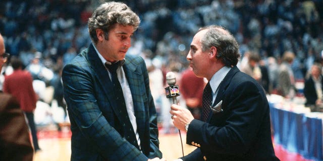 Sportscaster Billy Packer (left) interviews coach Bobby Knight after Indiana's victory in the NCAA Final Four.
