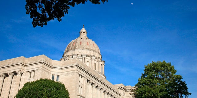 Moon rises over the afternoon sun lighted Missouri state capitol building in Jefferson City, Jefferson City is located in the center of Missouri along the Missouri River. 