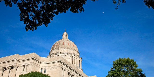 Moon rises over the afternoon sun lighted Missouri state capitol building in Jefferson City, Jefferson City is located in the center of Missouri along the Missouri River. 