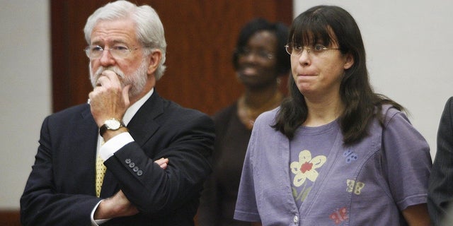 Andrea Yates, right, stands with her attorney, George Parnham, as the verdict is read in her retrial on July 26, 2006, in Houston.