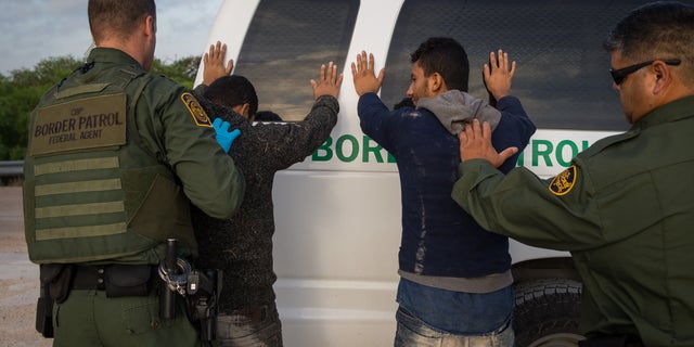 Border Patrol agents apprehend illegal immigrants shortly after they crossed the border from Mexico into the United States, March 26, 2018, in the Rio Grande Valley Sector near McAllen, Texas. (Loren Elliott / AFP via Getty Images)