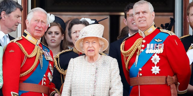 From left: Prince Charles, Queen Elizabeth II and Prince Andrew watch a flypast from the balcony of Buckingham Palace during Trooping The Colour, the Queen's annual birthday parade, in London on June 8, 2019.