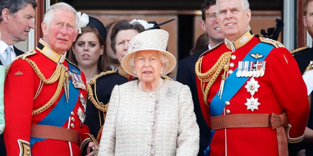 From left: Prince Charles, Queen Elizabeth II and Prince Andrew watch a flypast from the balcony of Buckingham Palace during Trooping The Colour, the Queen's annual birthday parade, in London on June 8, 2019.