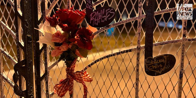 Fans pay tribute on the gates of Graceland following Lisa Marie Presley's death.